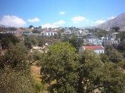 The unpaved road in Afrati that lead us past a valley with churches and houses.